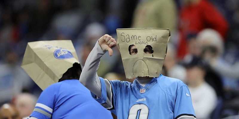 Detroit Lions fan with bag on head and thumbs down